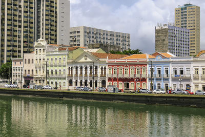 Buildings in city against cloudy sky