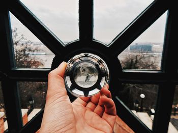 Close-up of person holding a glassball