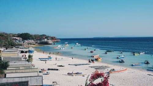 High angle view of people on beach against clear sky