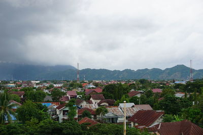 Houses in town against sky