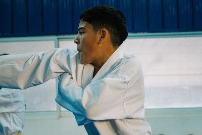 Close-up portrait of taekwondo student punching