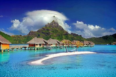 Scenic view of sea and mountains against sky