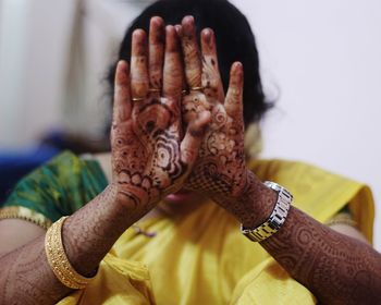 Close-up of young woman showing henna tattoo