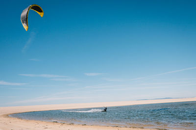 Scenic view of beach against blue sky