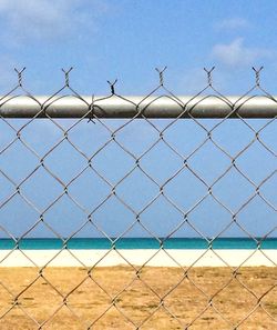 View of chainlink fence by sea