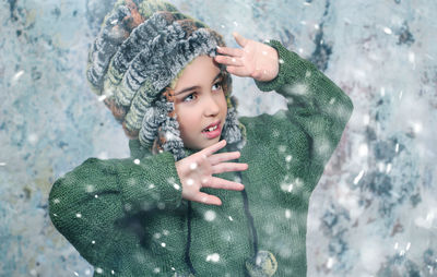 Close-up portrait of woman standing in snow