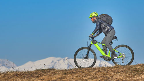 Young man with beard in mountain bike