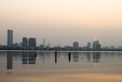 City at waterfront during sunset