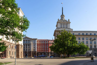 Buildings in city against clear sky