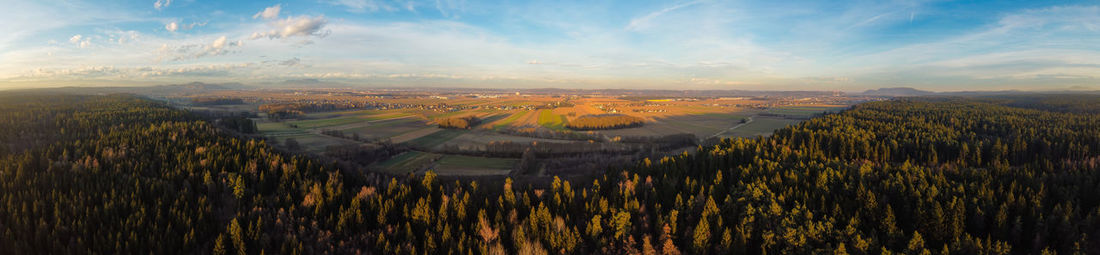 Panoramic view of agricultural field against sky during sunset