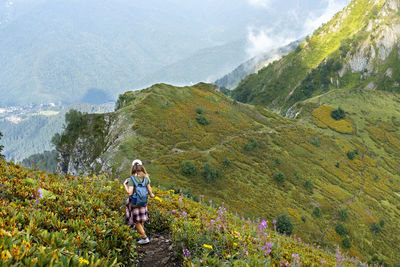 Man standing on mountain against plants