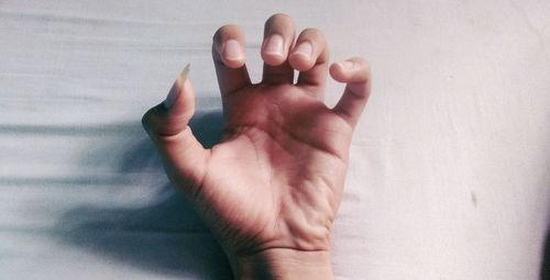 Close-up of person hand on wall