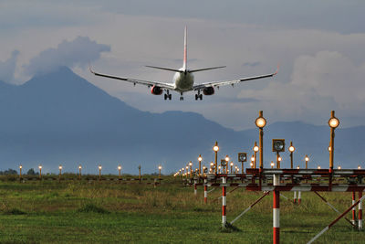 Airplane on field against sky during sunset