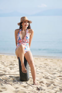 Full length of young woman on beach