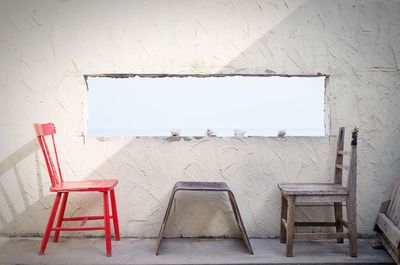 Empty chairs against wall