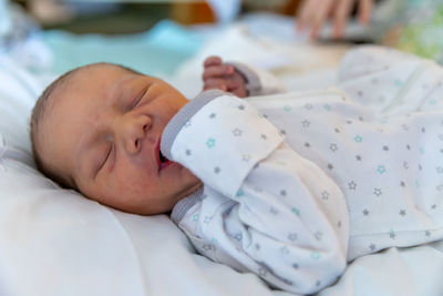 Cute baby sleeping on bed