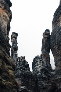 Low angle view of rock formation against clear sky