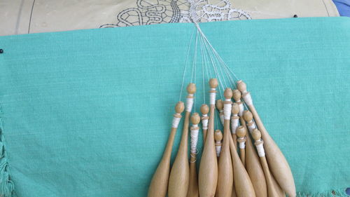 Close-up of bobbin lace on blue fabric