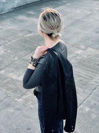 Rear view of woman standing on footpath