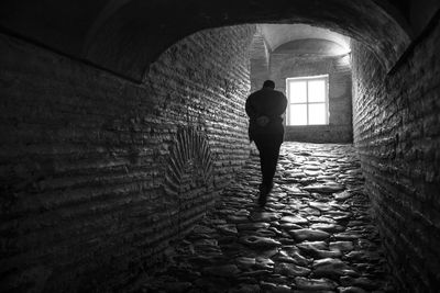 Woman standing in tunnel