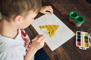 High angle view of man holding paper on table