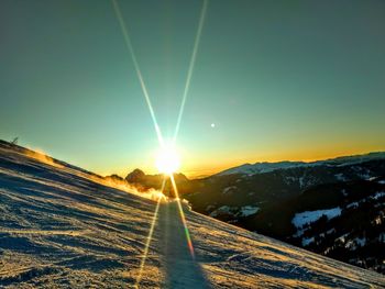 Scenic view of snowcapped mountains against sky during winter