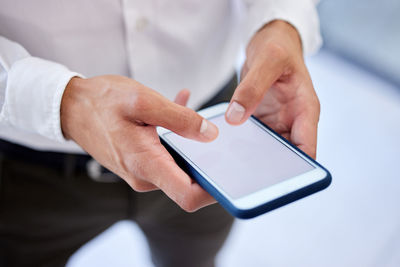 Midsection of man using digital tablet