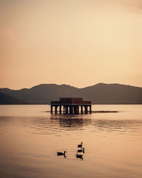 Scenic view of lake against sky during sunset