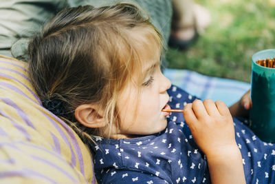 Close-up of cute girl relaxing outdoors