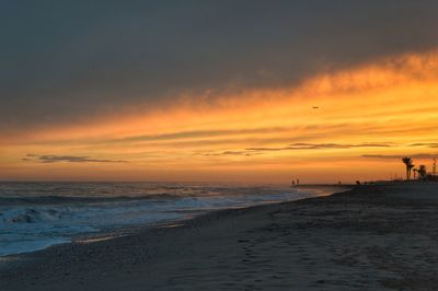 Scenic view of beach against sky during sunset