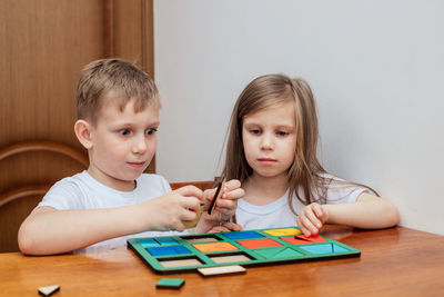 Cute kids playing toy at home