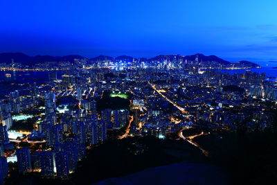 High angle view of city lit up at night