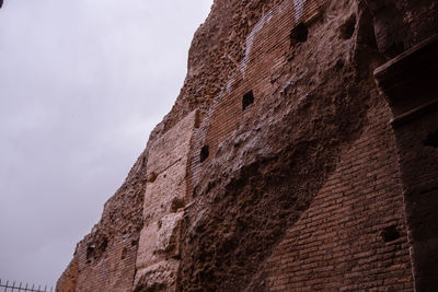 Low angle view of wall against sky