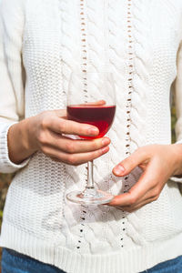 Woman holding a glass on wine 