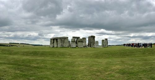 Built structure on field against cloudy sky