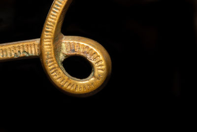 Close-up of metallic object against black background