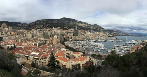 High angle view of townscape by sea against sky