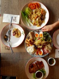 Cropped image of person with meal at table