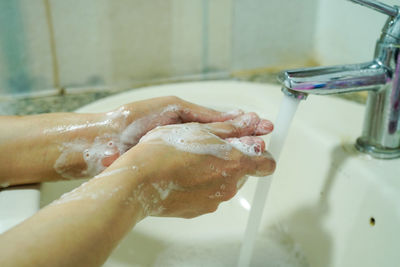 Midsection of woman in bathroom at home