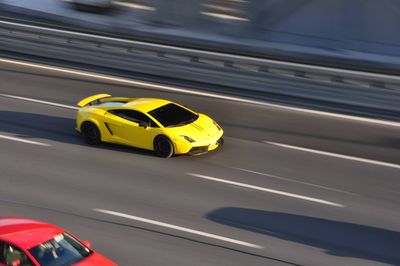 High angle view of yellow toy car on road