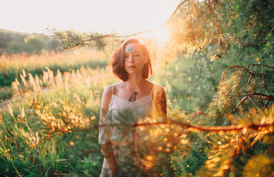 Young woman standing on field