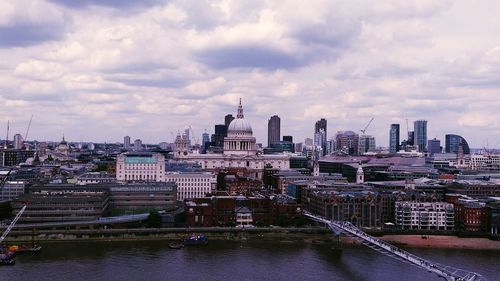 St paul cathedral and buildings in city against cloudy sky