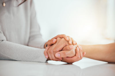 Midsection of woman holding hands