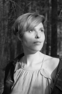 Portrait of beautiful woman standing against blurred background