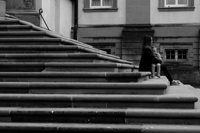 Woman on staircase of building