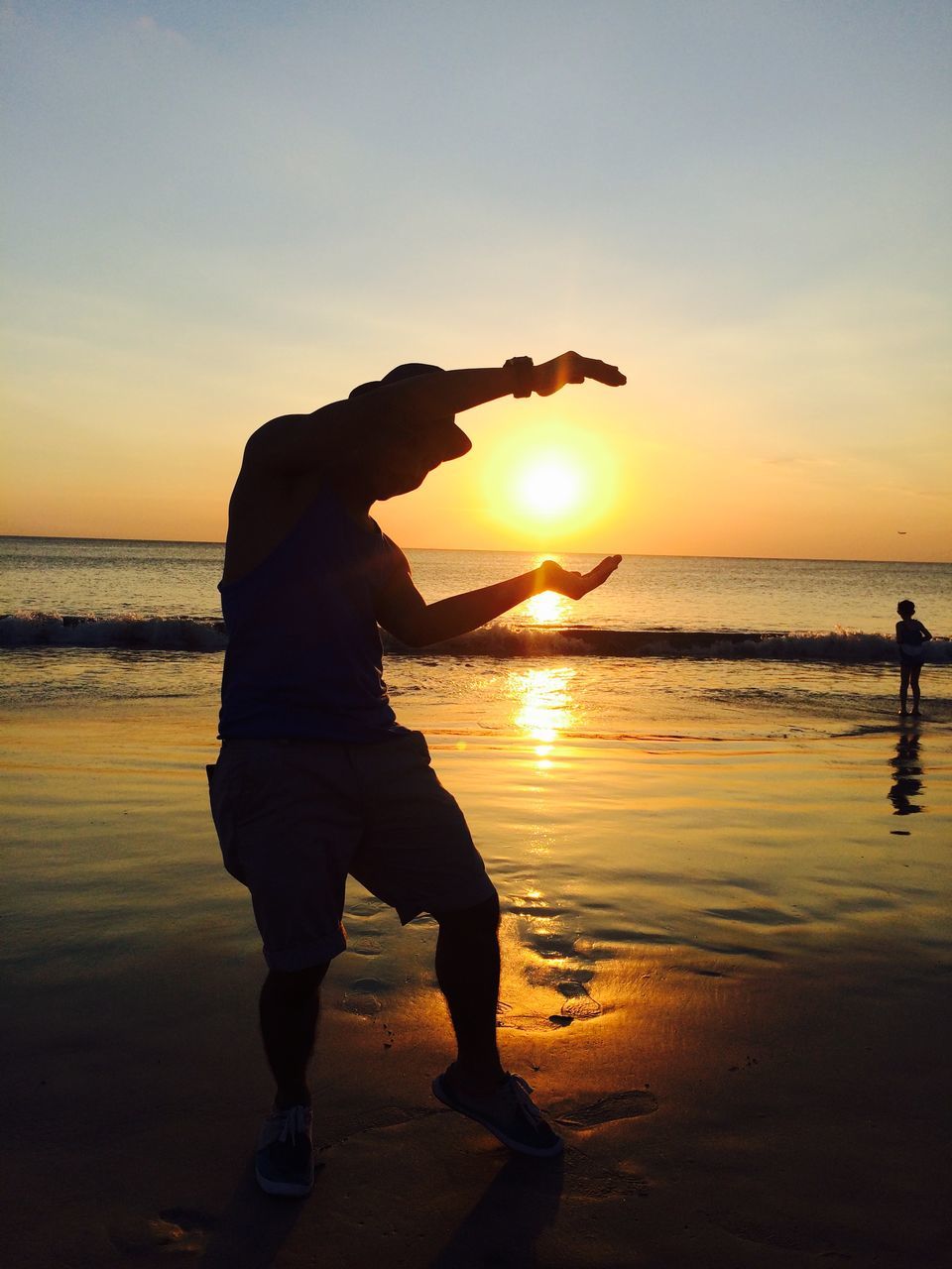 sea, sunset, horizon over water, beach, water, sun, shore, silhouette, scenics, sky, beauty in nature, tranquil scene, leisure activity, orange color, tranquility, lifestyles, standing, vacations, men