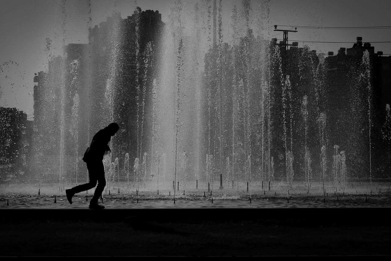 full length, silhouette, lifestyles, leisure activity, water, men, motion, walking, rear view, splashing, standing, person, enjoyment, weather, wet, sky, nature, side view
