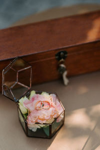 High angle view of rings over flowers in jewelry box