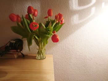 Close-up of tulips in vase on table at home