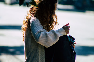 Rear view of woman holding umbrella